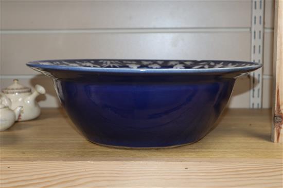 A 19th century Chinese white slip decorated blue ground basin diameter 34cm